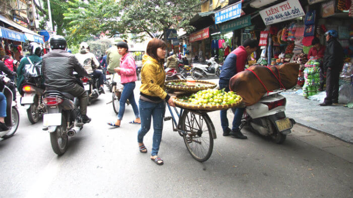 Vietnames Fruit Vendor sells from her bicycle