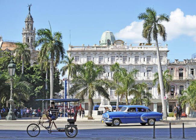 Old cars and pedestrians show the quiet lifestyle of Havana, Cuba